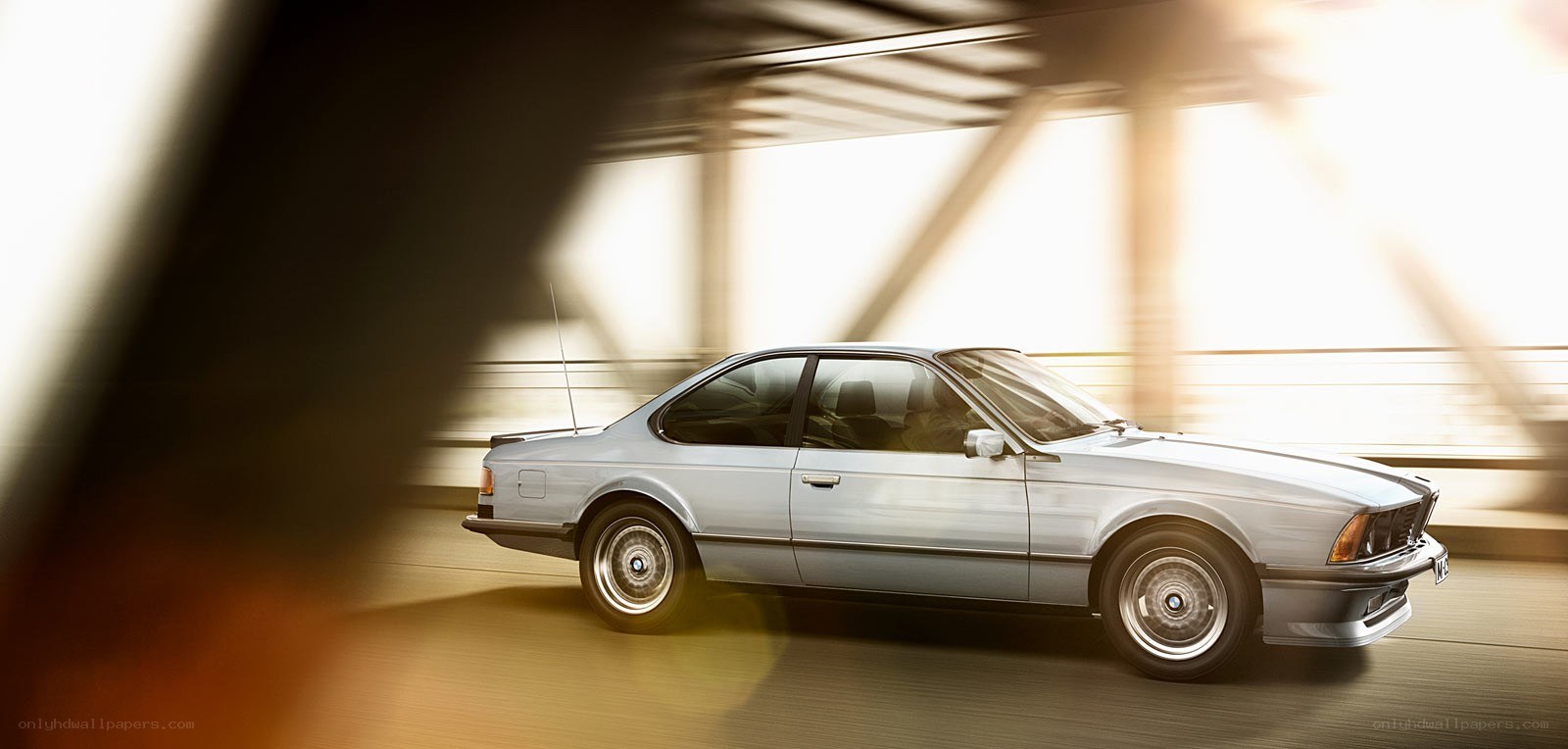 silver bmw coupe in motion