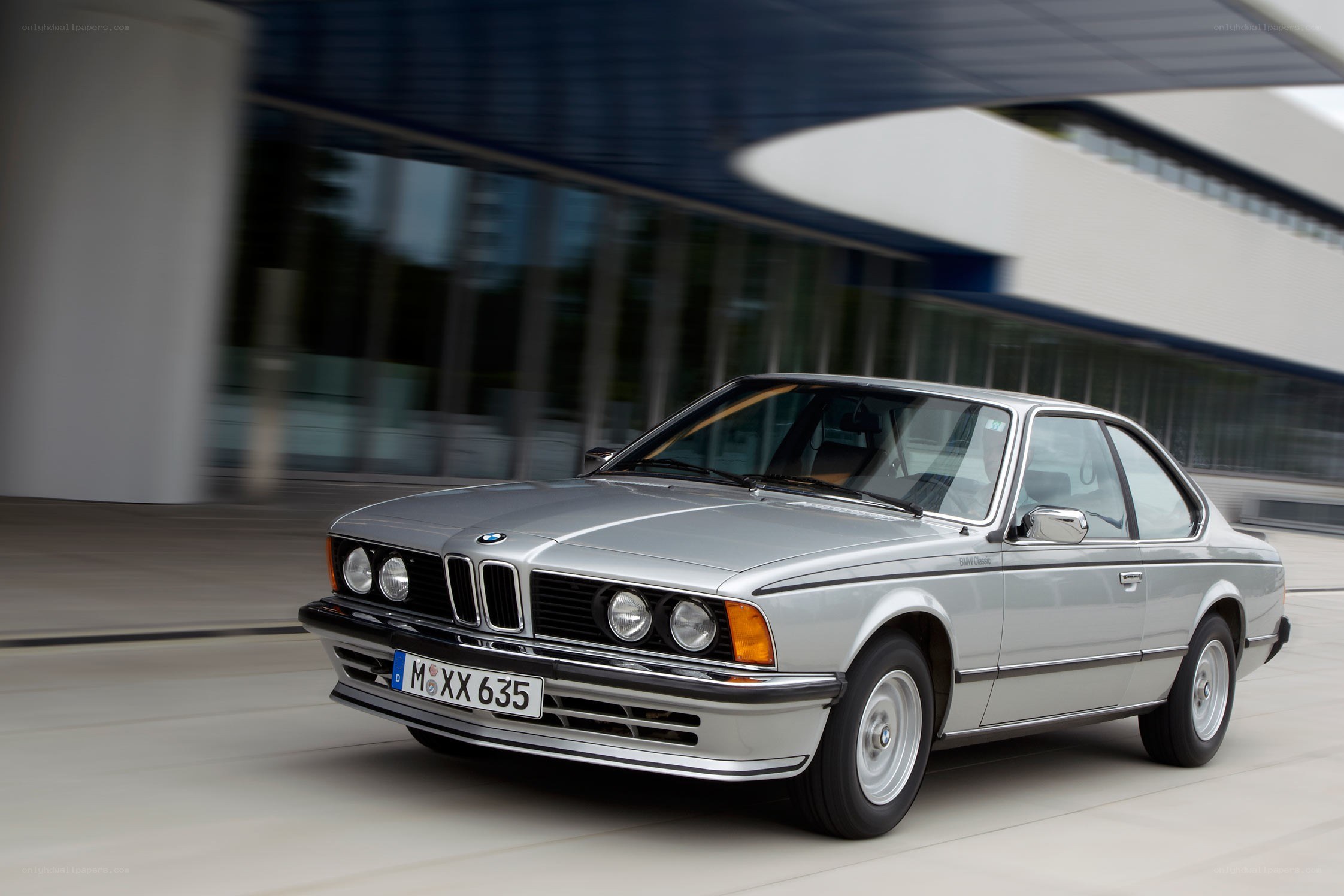 silver bmw coupe in motion