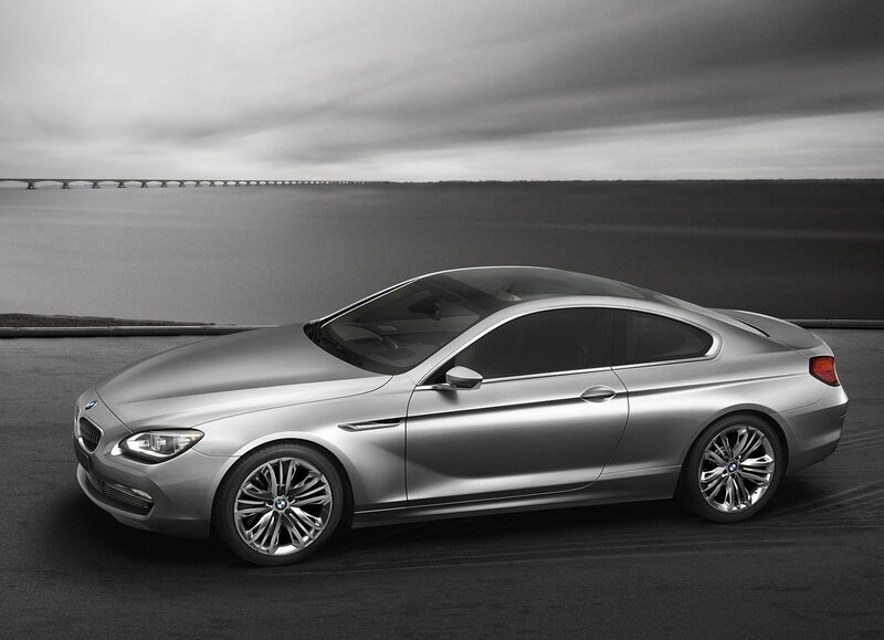 Silver BMW coupe on a coastal road