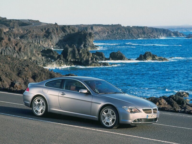 Silver BMW coupe on coastal road