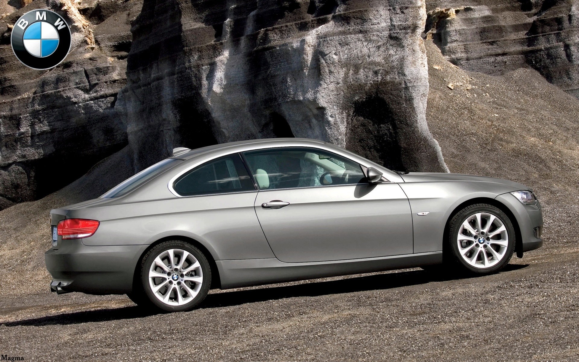 silver bmw coupe on rocky terrain