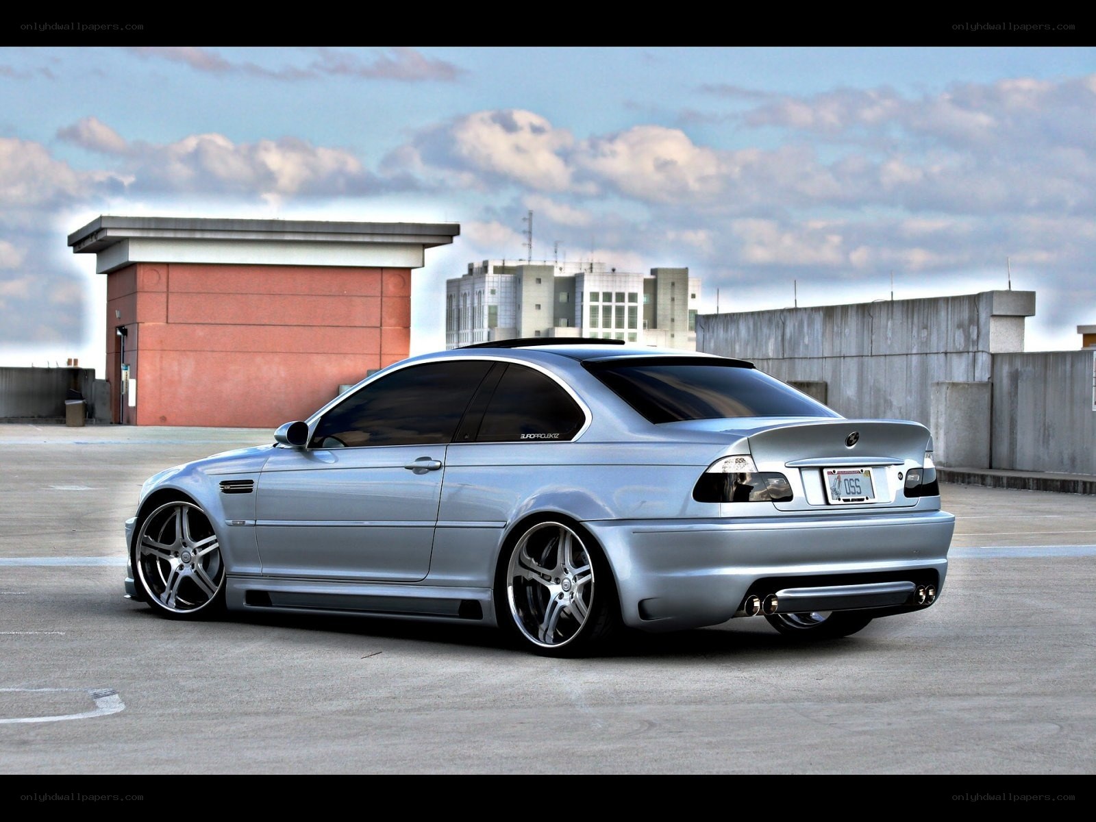 silver bmw coupe on rooftop