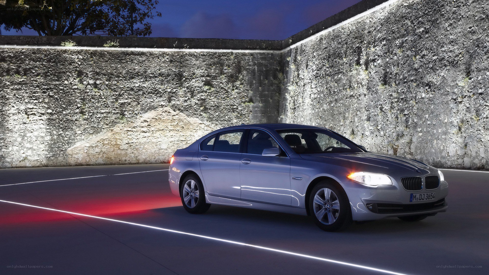 Silver BMW driving at night
