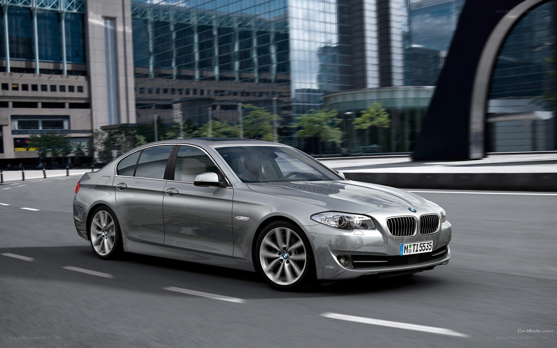 silver bmw driving in city