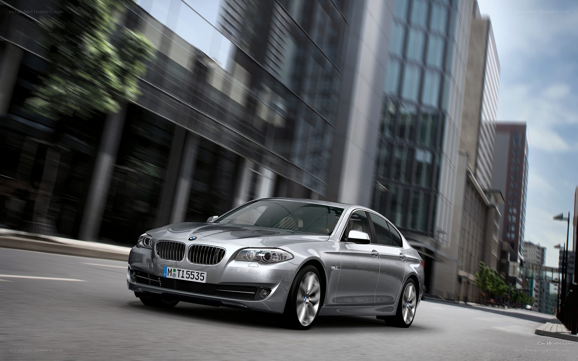 silver bmw driving in city