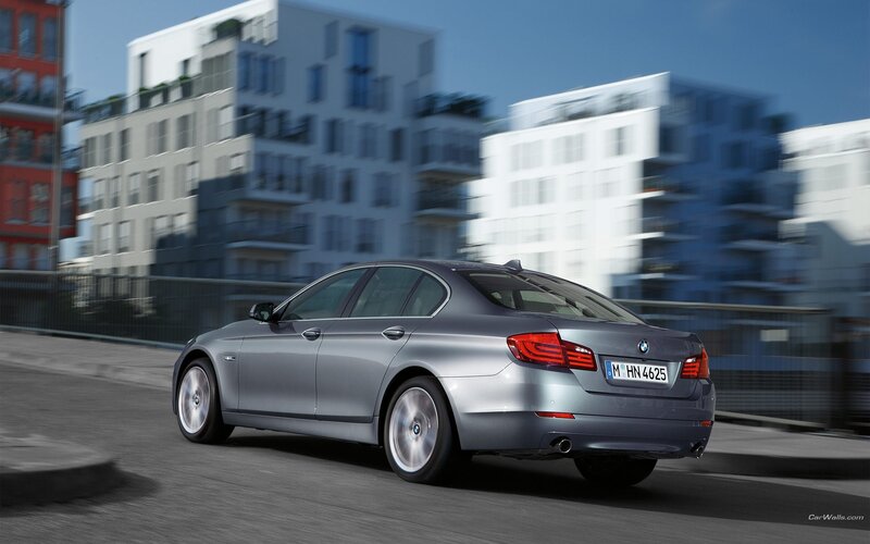 silver bmw driving in city