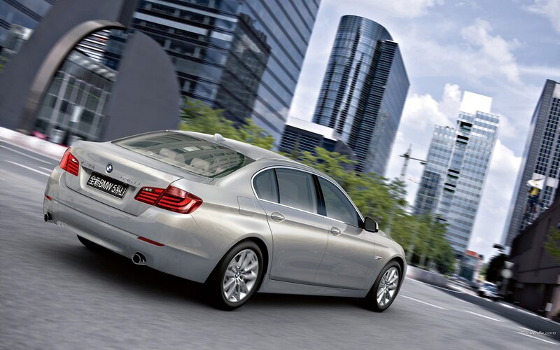 silver bmw driving in city