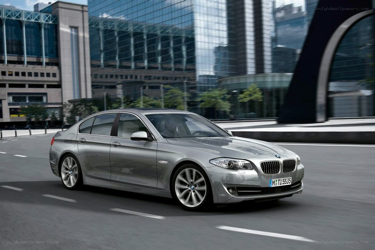 silver bmw driving in city