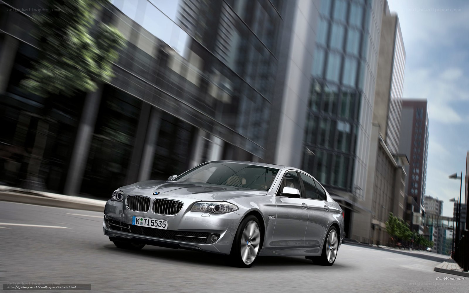 silver bmw driving in city