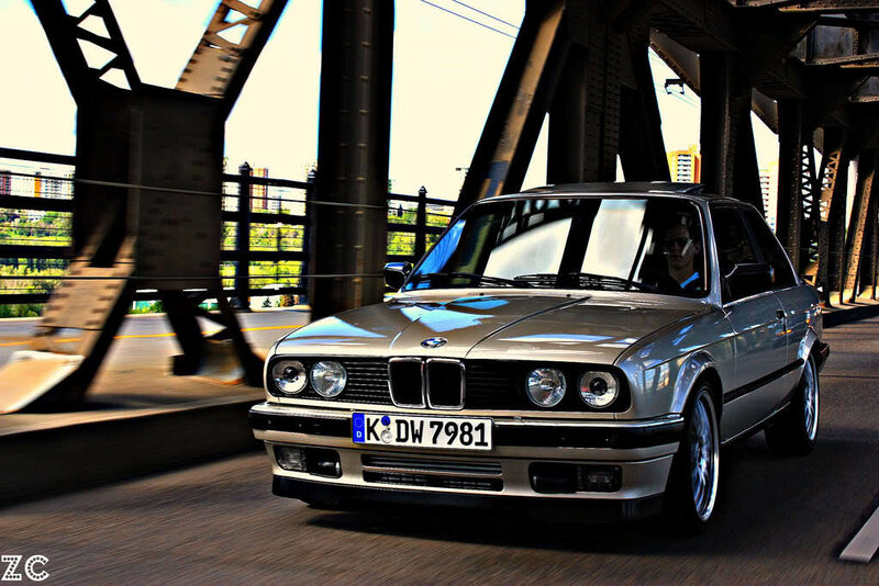 silver bmw driving on a bridge