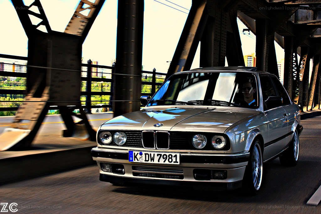 silver bmw driving on a bridge