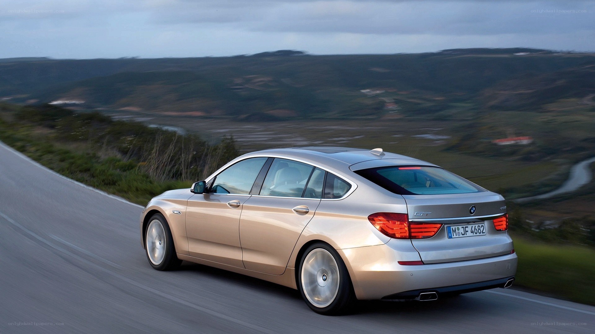 silver bmw driving on a road