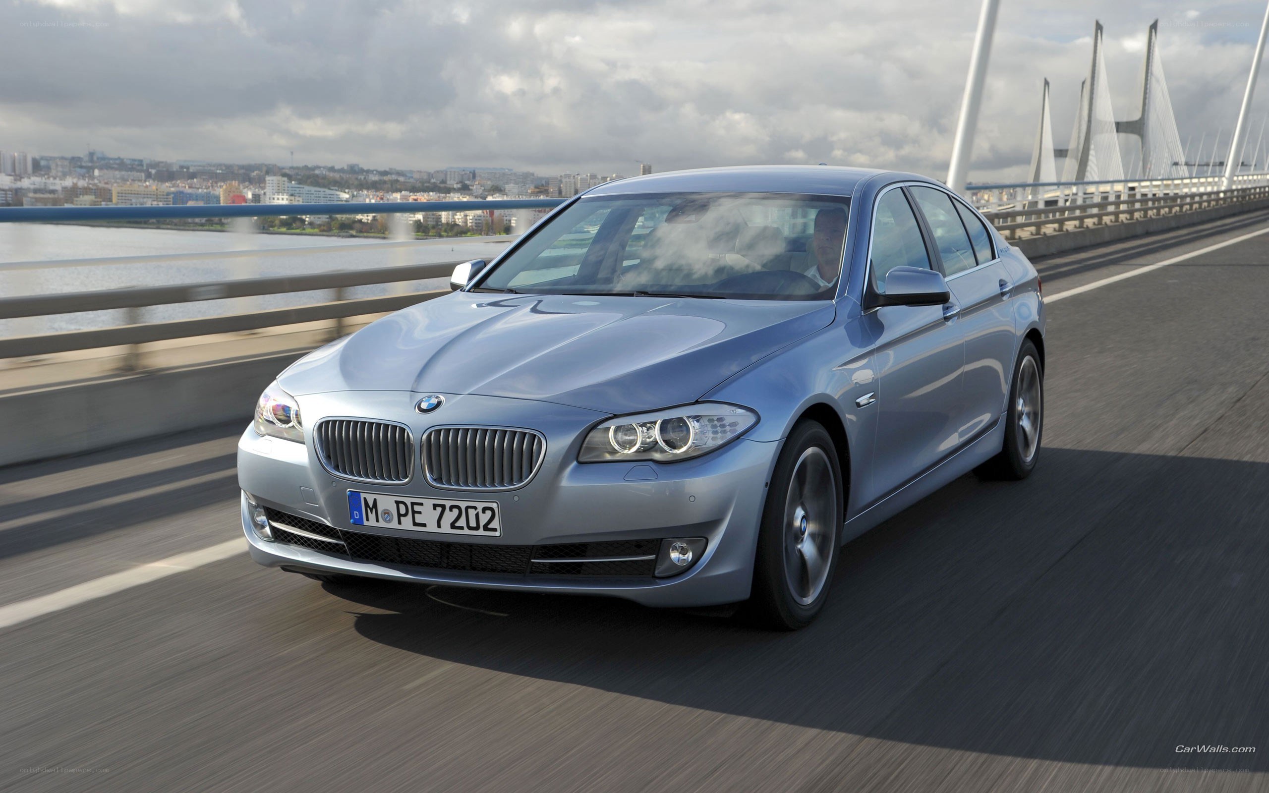 silver bmw driving on bridge