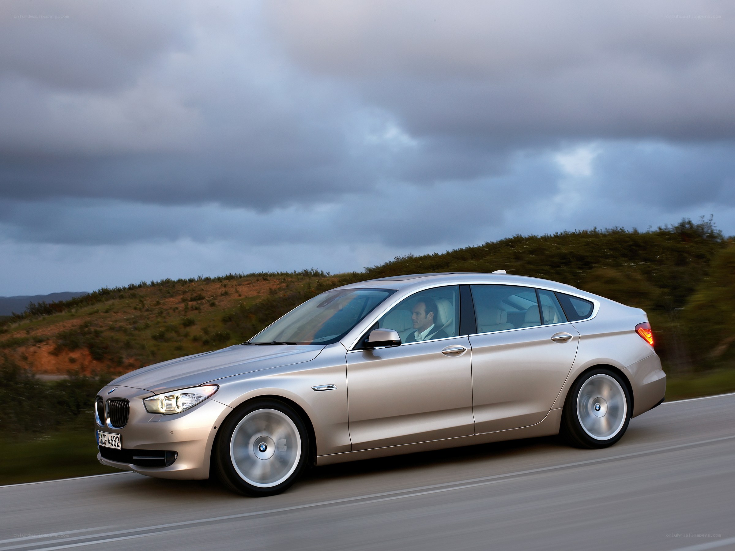 silver bmw driving on road