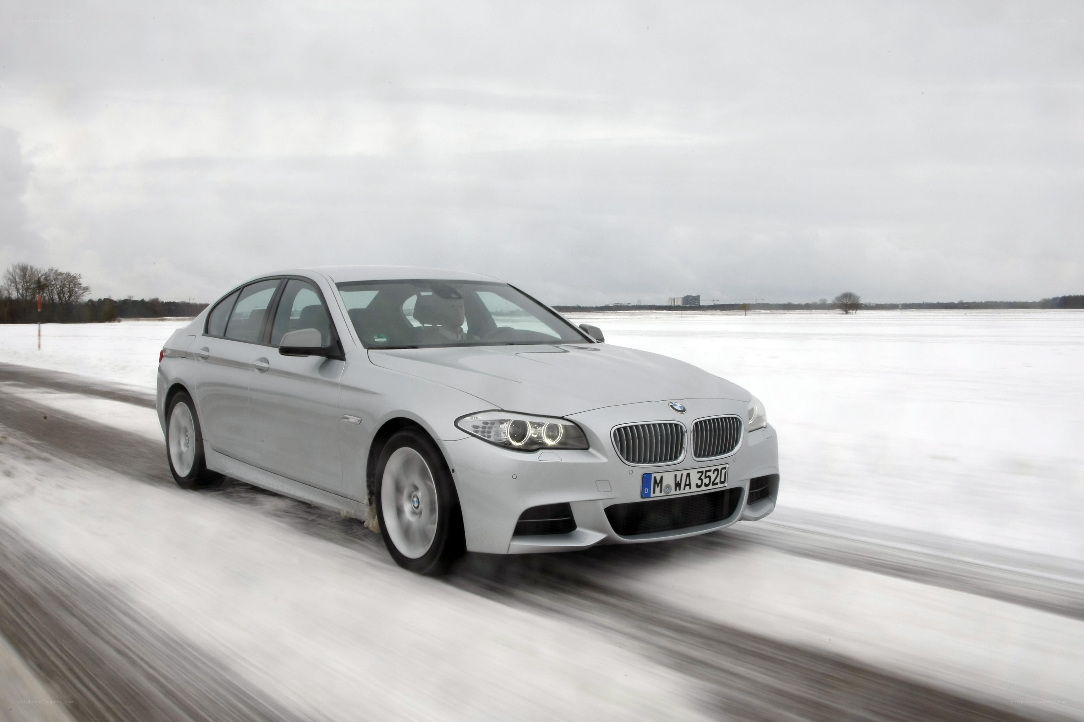 Silver BMW driving on snow