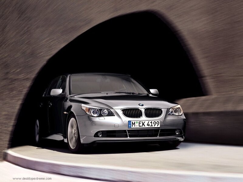 silver bmw driving through tunnel