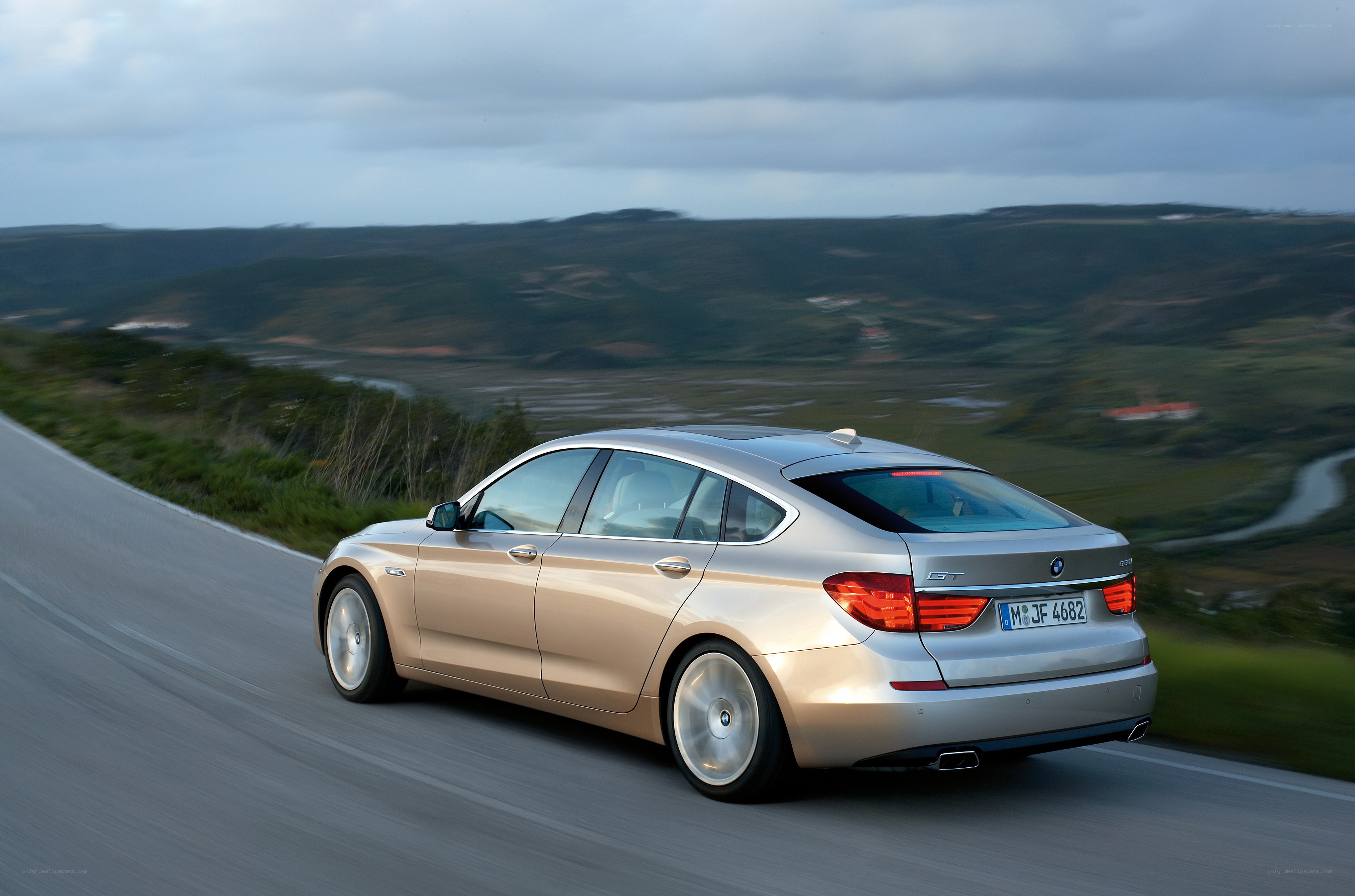 silver bmw gt on winding road