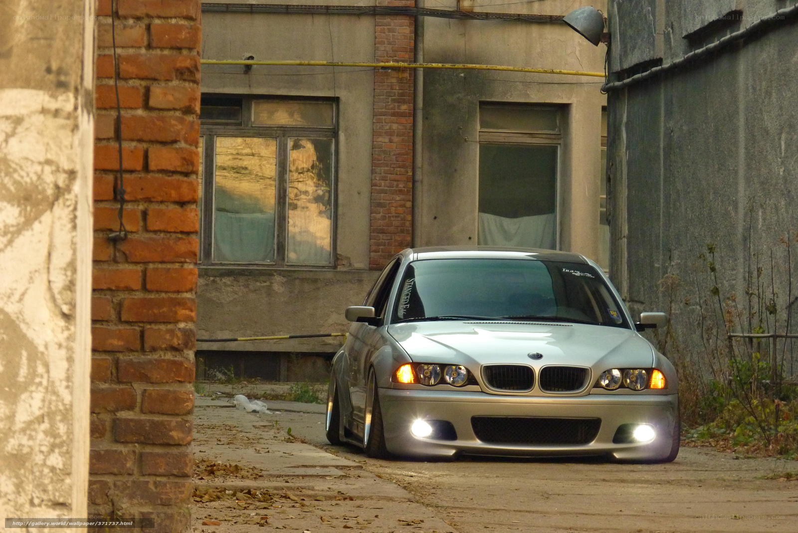 silver bmw in alleyway