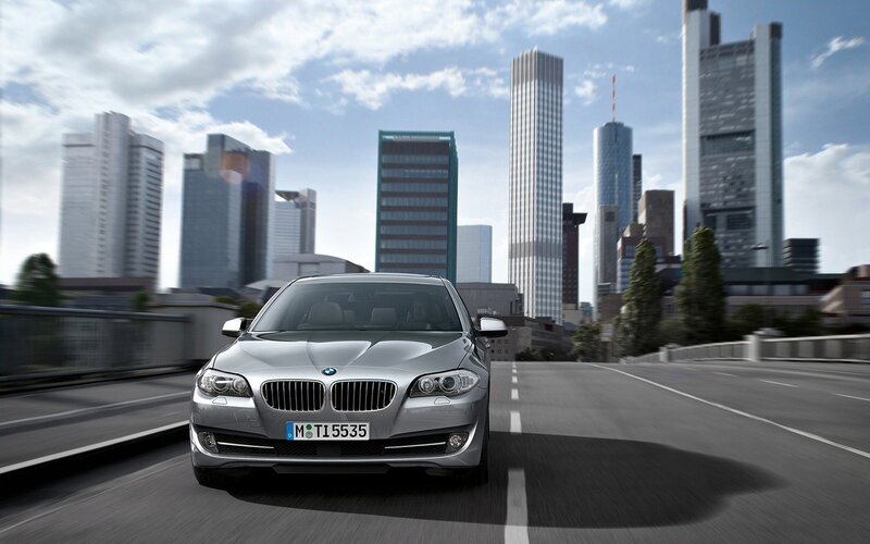 Silver BMW in city traffic