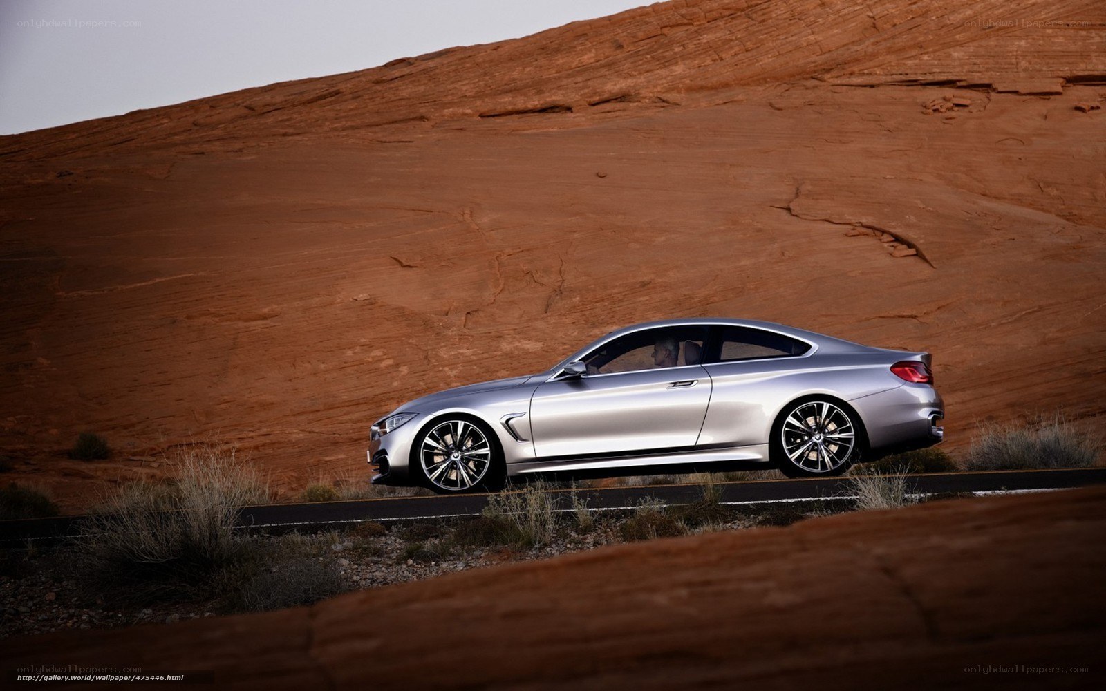 Silver BMW in desert landscape