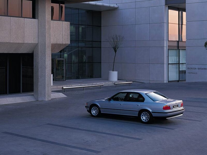 Silver BMW in front of modern building