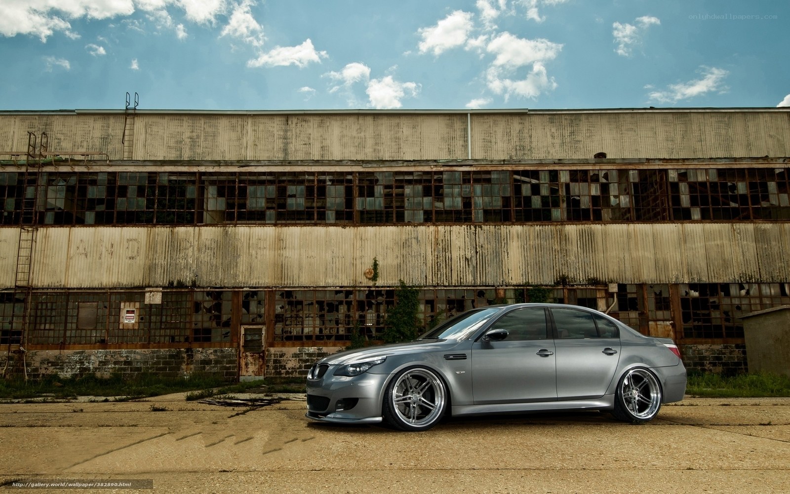 Silver BMW in front of old building