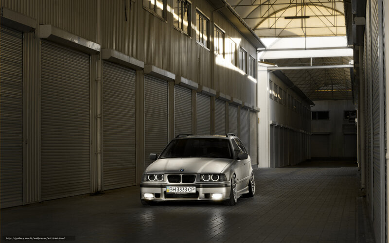 Silver BMW in warehouse alley