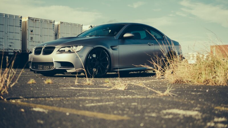 Silver BMW M3 Coupe — Gray, Dramatic, Afternoon, Photograph, Shipping Containers