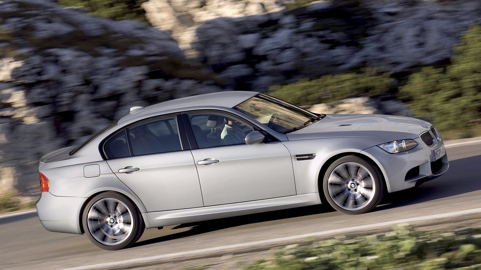 silver bmw m3 driving on road