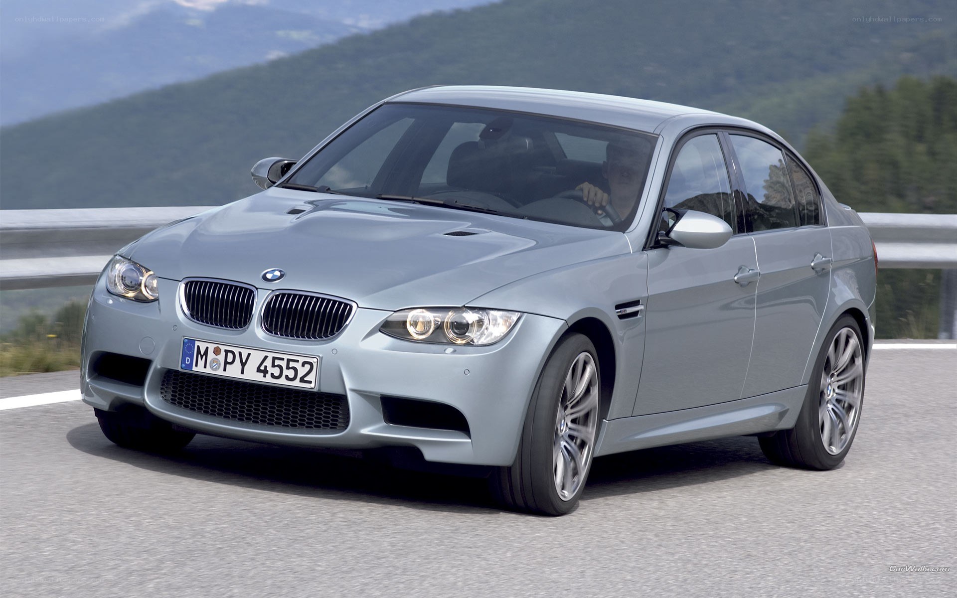 silver bmw m3 on mountain road