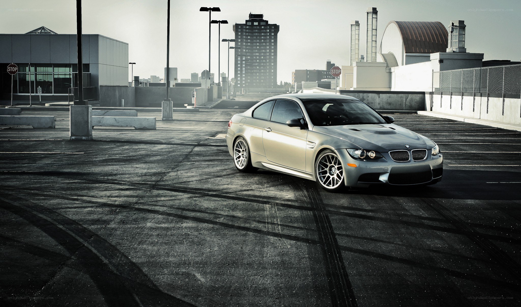 silver bmw m3 on rooftop parking