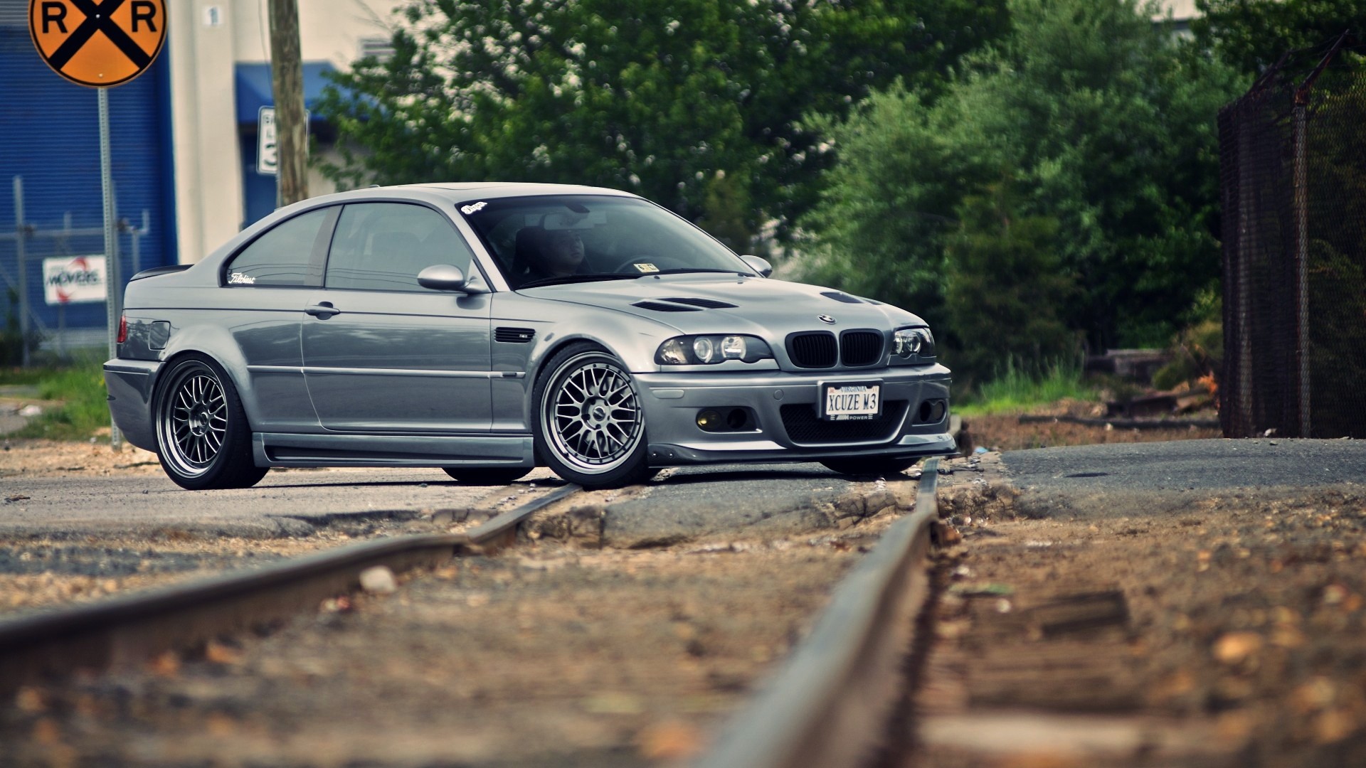 silver bmw m3 on train tracks