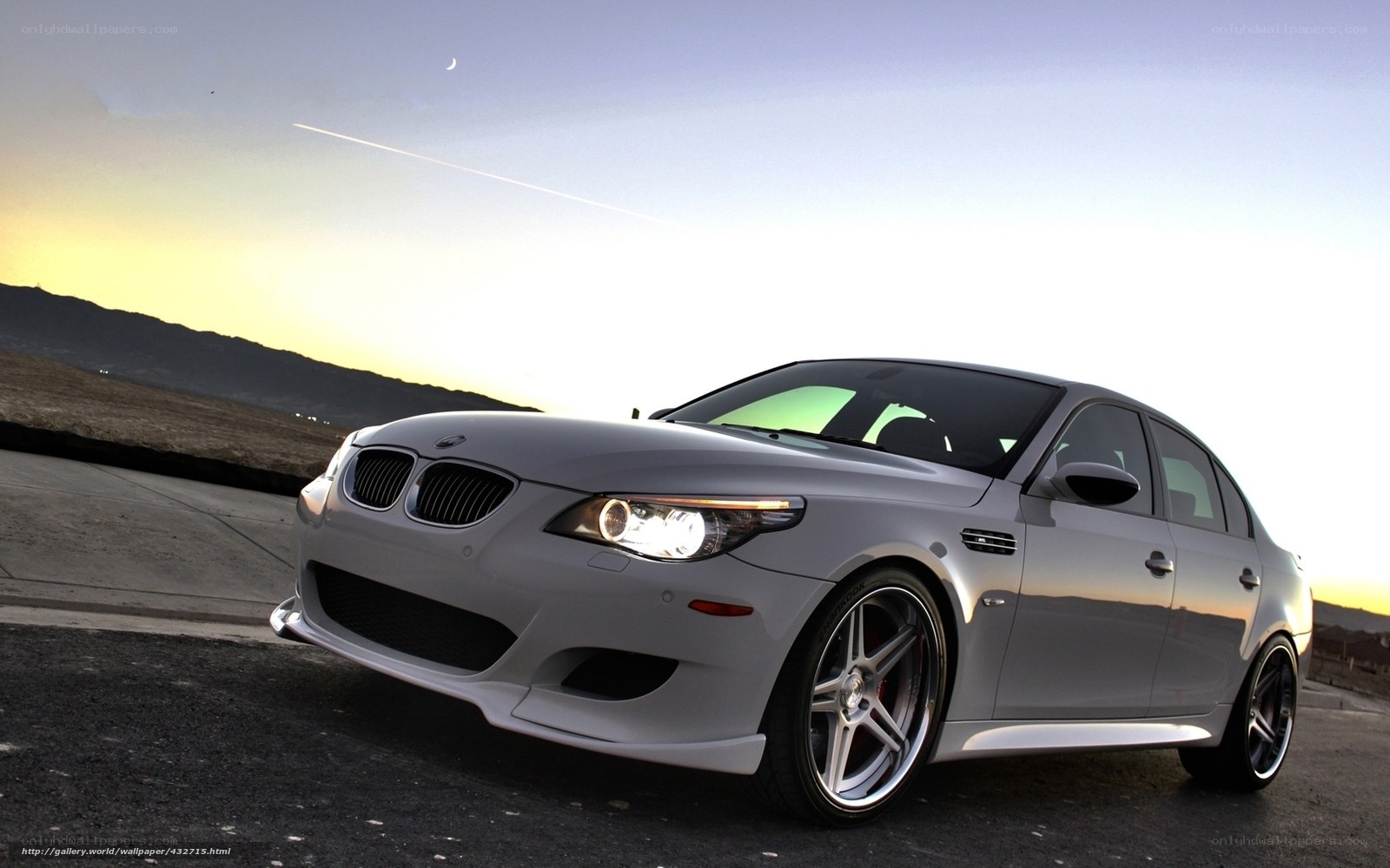 silver bmw m5 at sunset