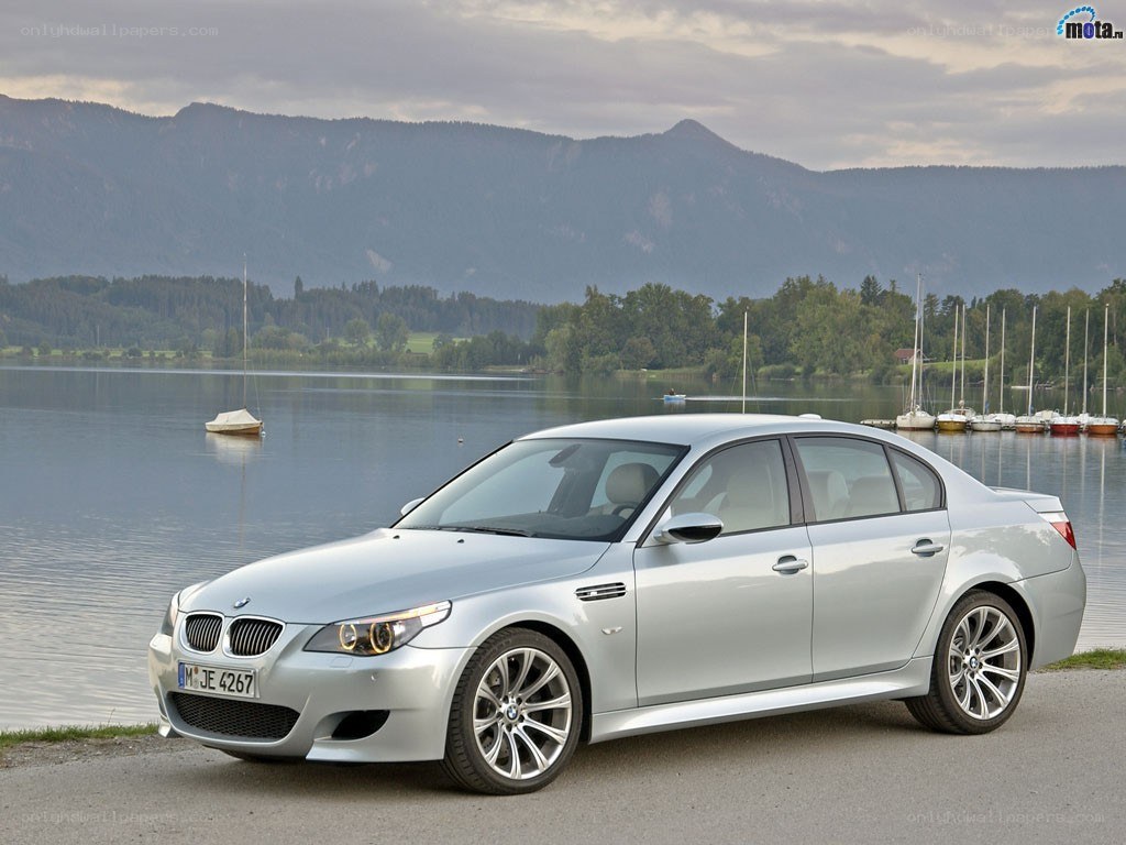 Silver BMW M5 by a lake