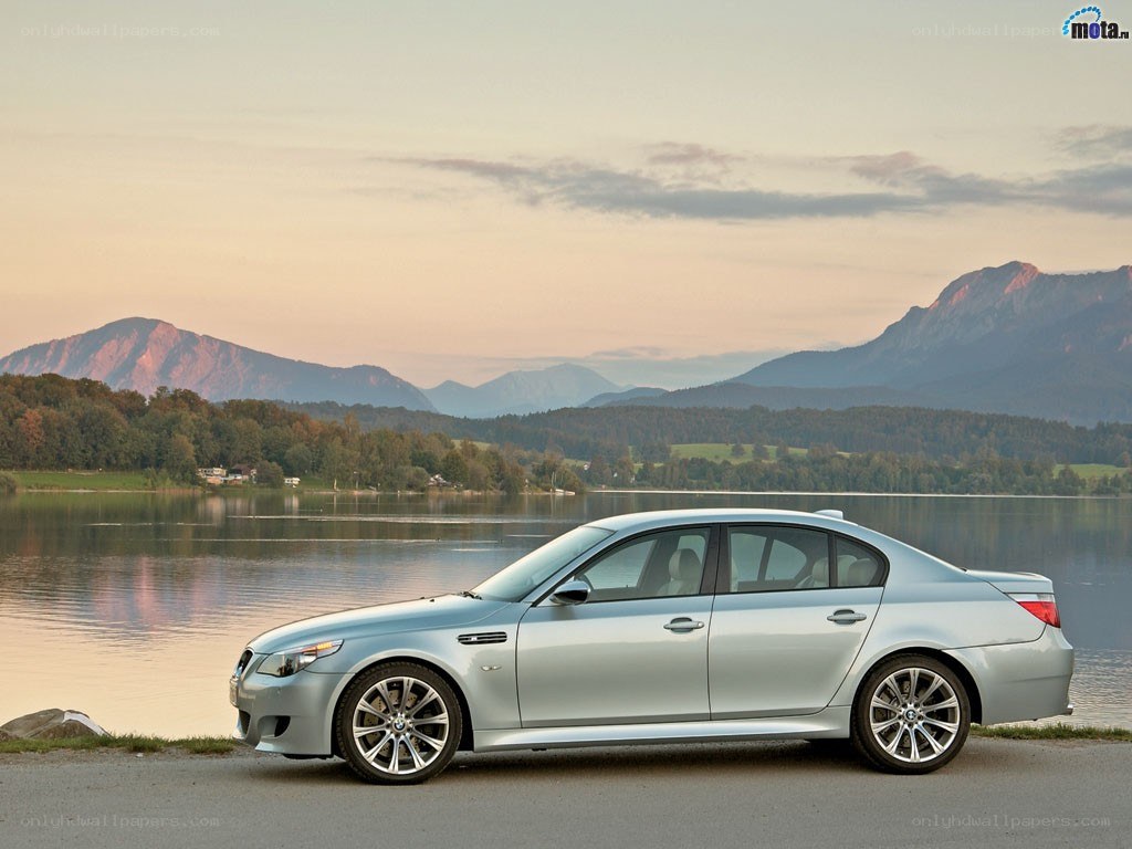 Silver BMW M5 by a lake