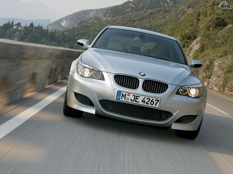 silver bmw m5 driving on mountain road