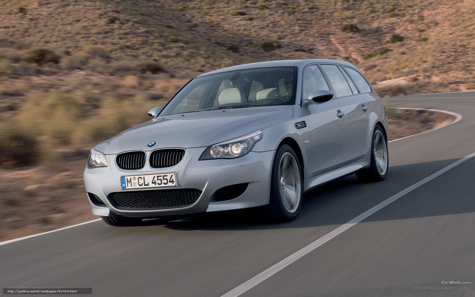 silver bmw m5 driving on road