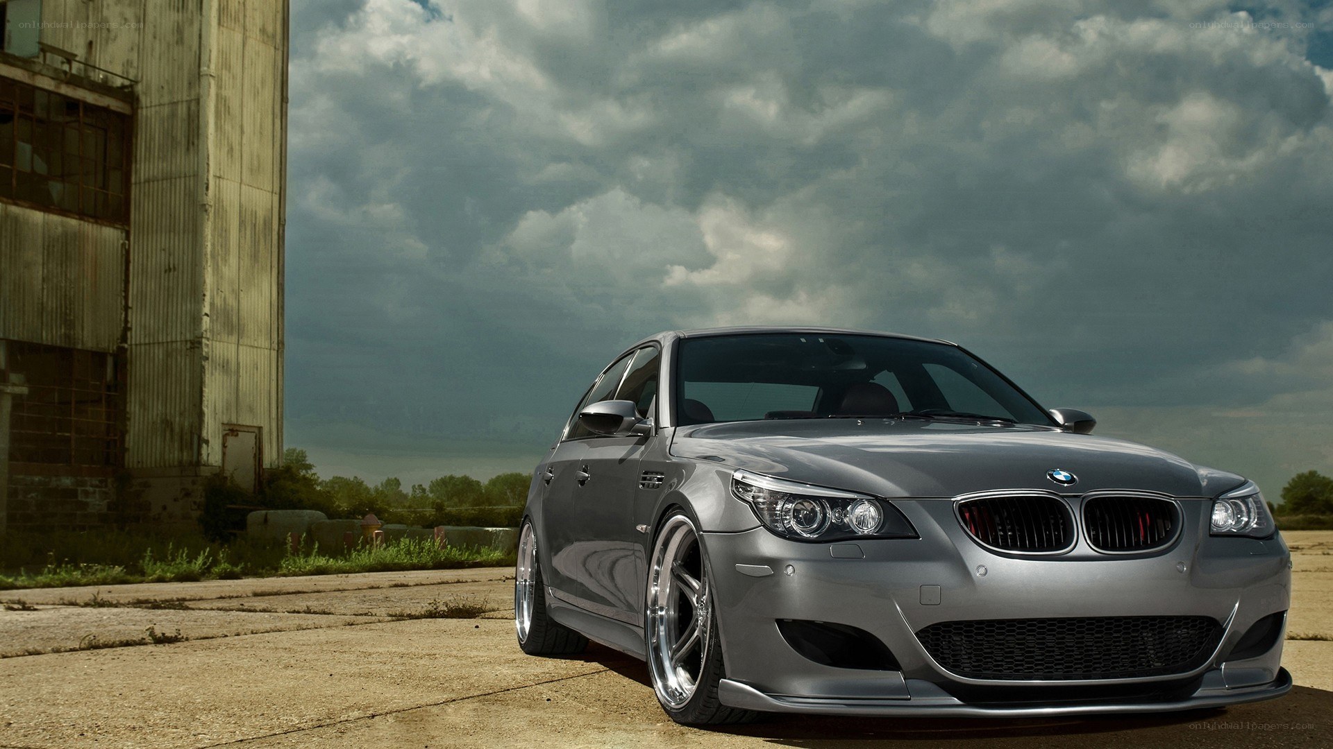 silver bmw m5 in industrial setting