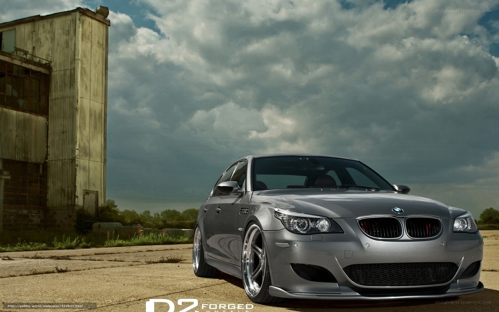 silver bmw m5 in industrial setting
