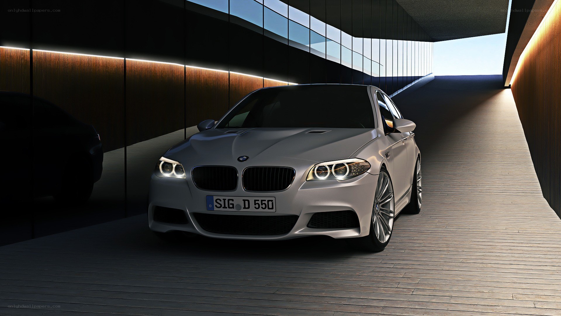 Silver BMW M5 in modern garage