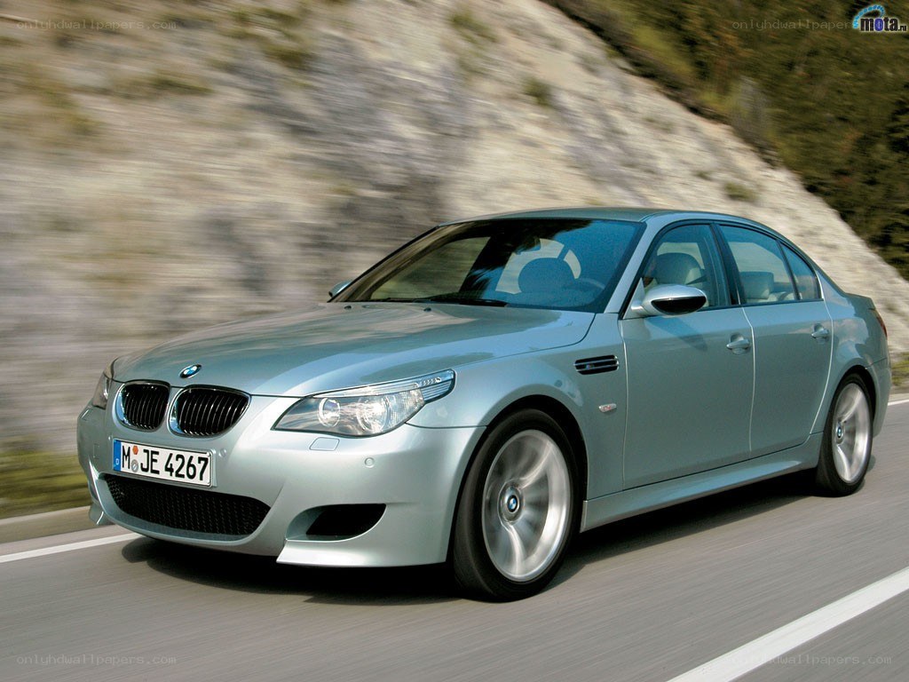 silver bmw m5 in motion