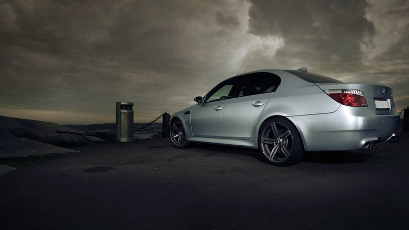silver bmw m5 on a cliff
