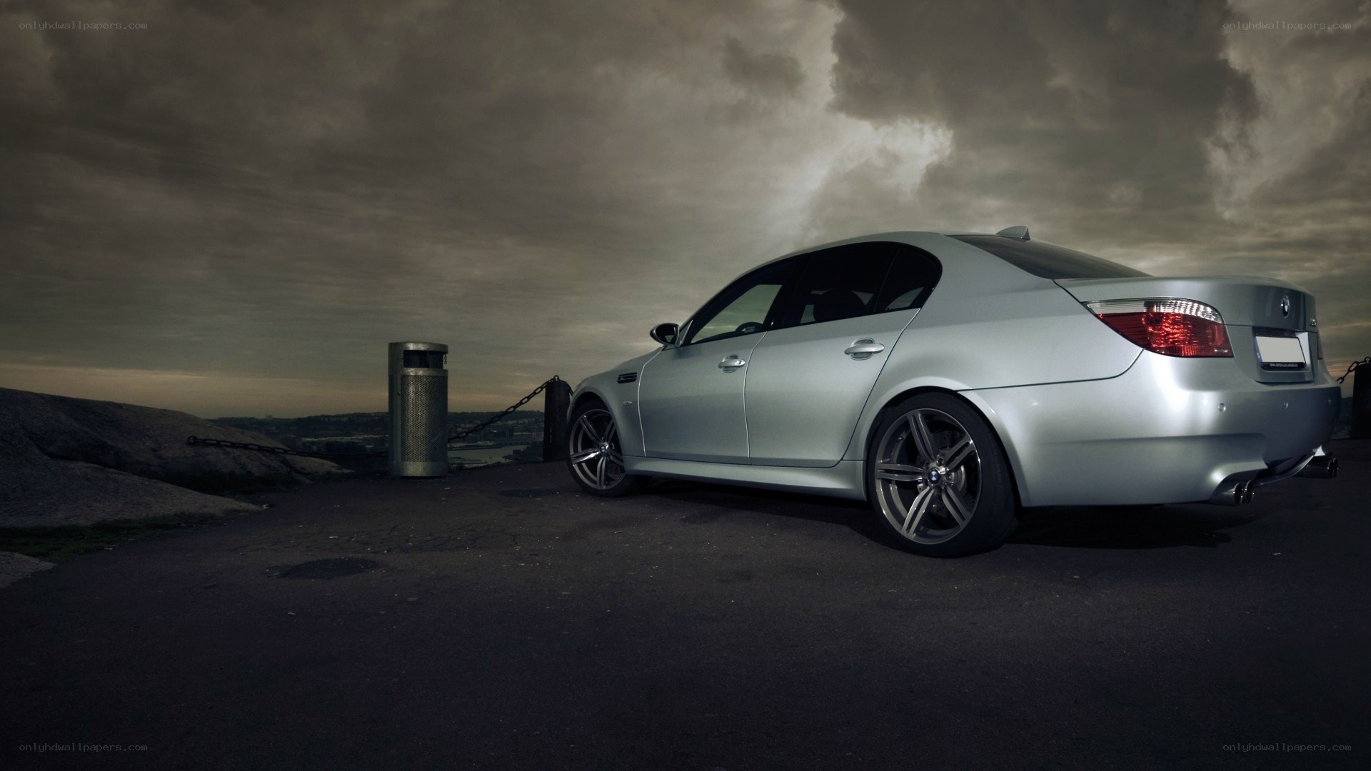 silver bmw m5 on a cliff