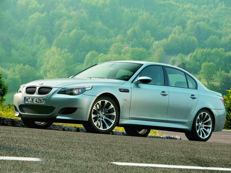 Silver BMW M5 on a scenic road