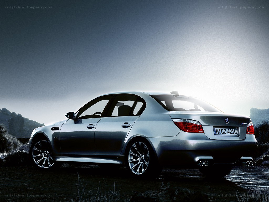 silver bmw m5 on rocky terrain