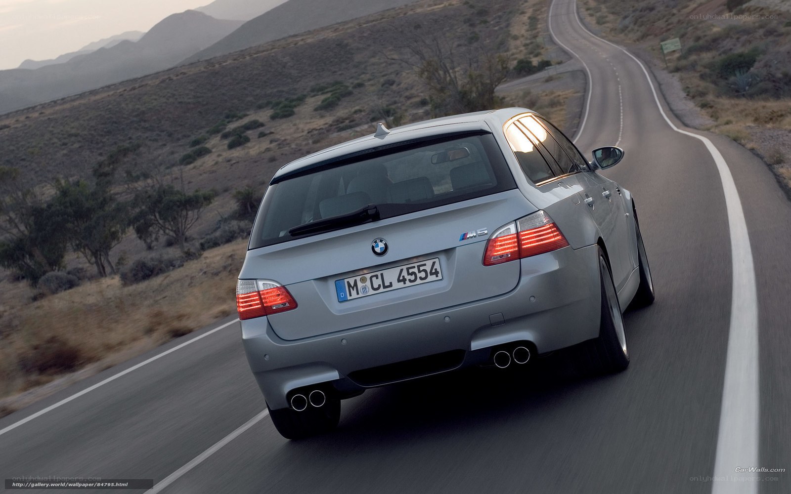 silver bmw m5 on winding road