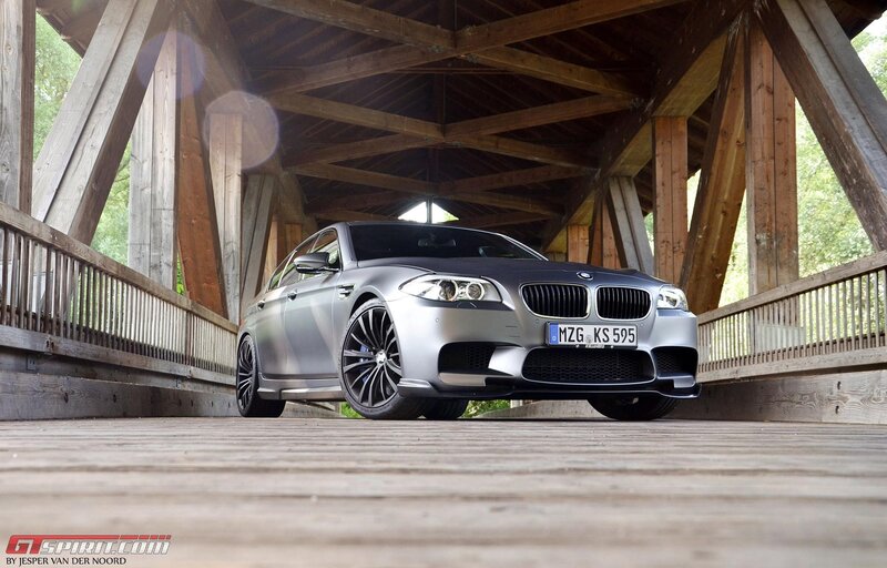 Silver BMW M5 on wooden bridge