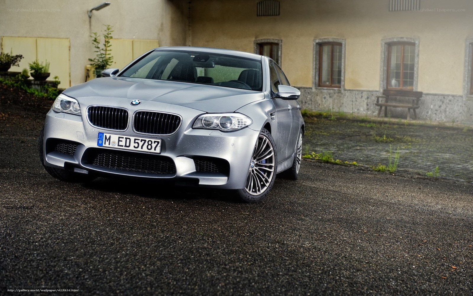 Silver BMW M5 parked outside