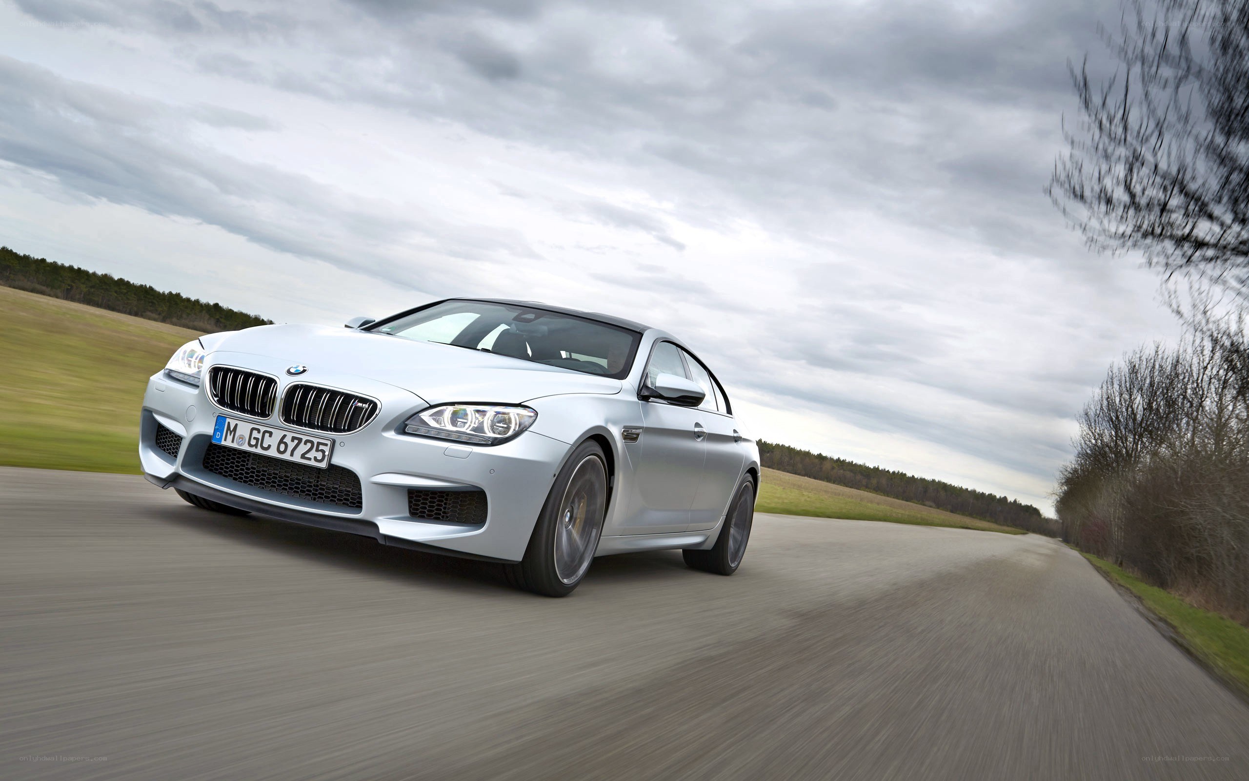 silver bmw m6 driving on road