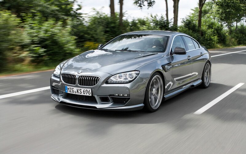 silver bmw m6 driving on road